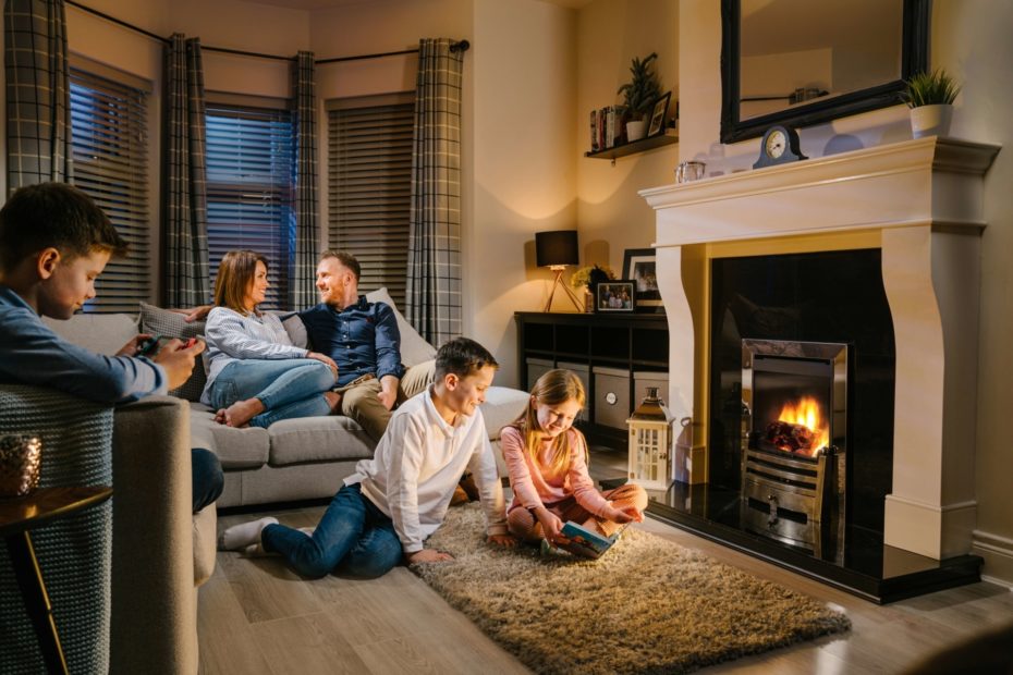 Family in warm living room infront of Gas Fire