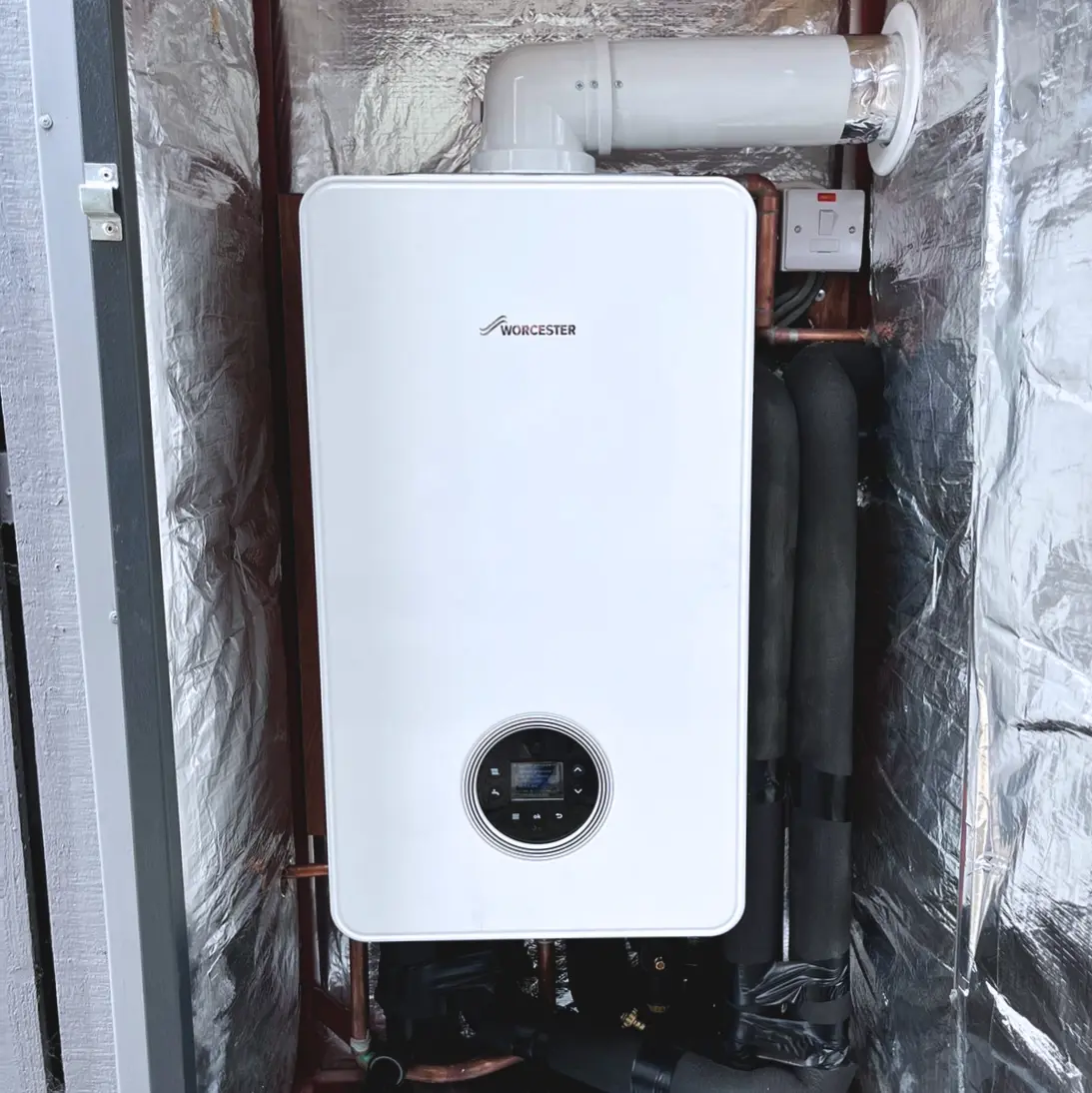 White Worcester Bosch Boiler in a metal case with insulation