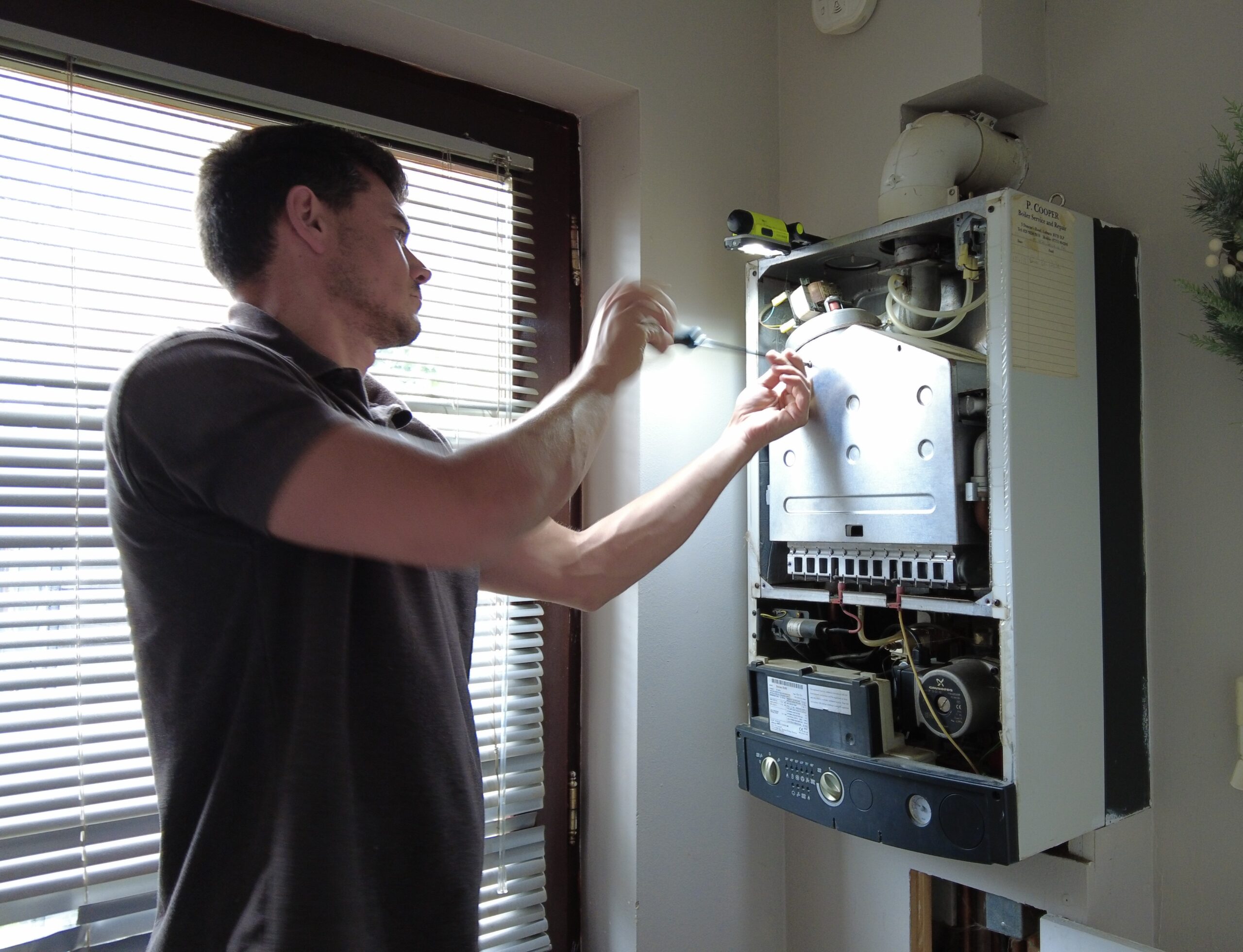 A Refresh NI gas engineer servicing a boiler