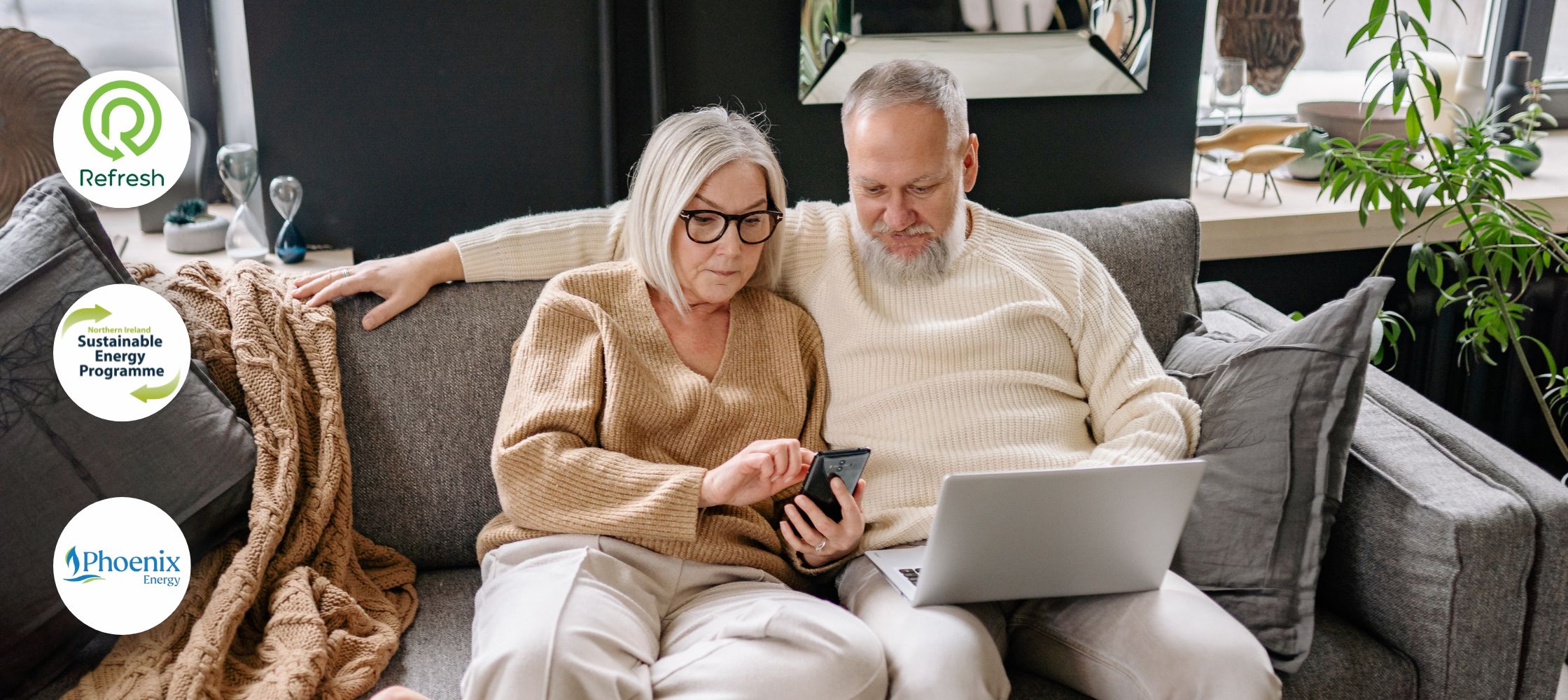 A couple on the couch looking at a laptop